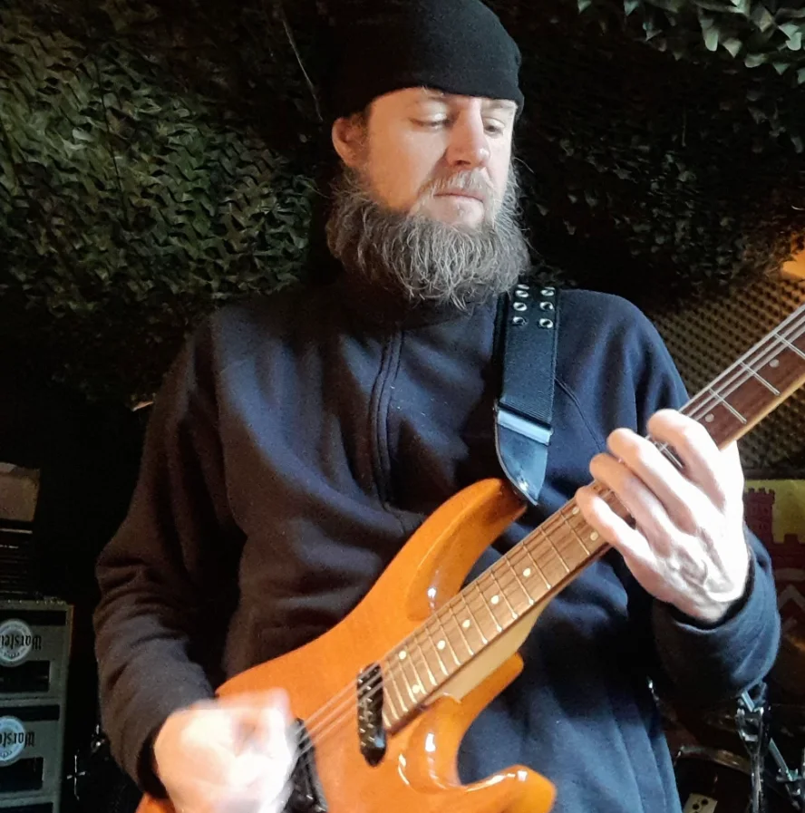 H. Stieghorst playing an electric guitar.
